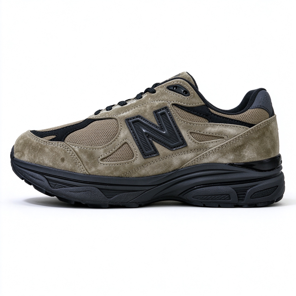 JJJJound x New Balance 990v3 classic collaboration model, Made in USA style. Premium brown suede matched with breathable mesh fabric, iconic dark black overlay, low-key vintage aesthetic, highly versatile for streetwear outfits.