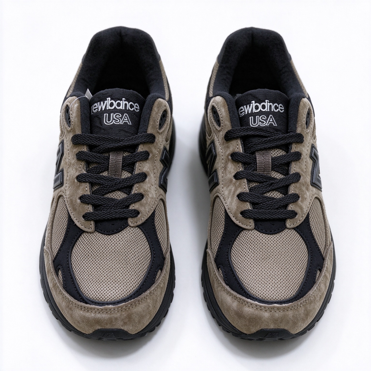 JJJJound x New Balance 990v3 classic collaboration model, Made in USA style. Premium brown suede matched with breathable mesh fabric, iconic dark black overlay, low-key vintage aesthetic, highly versatile for streetwear outfits.